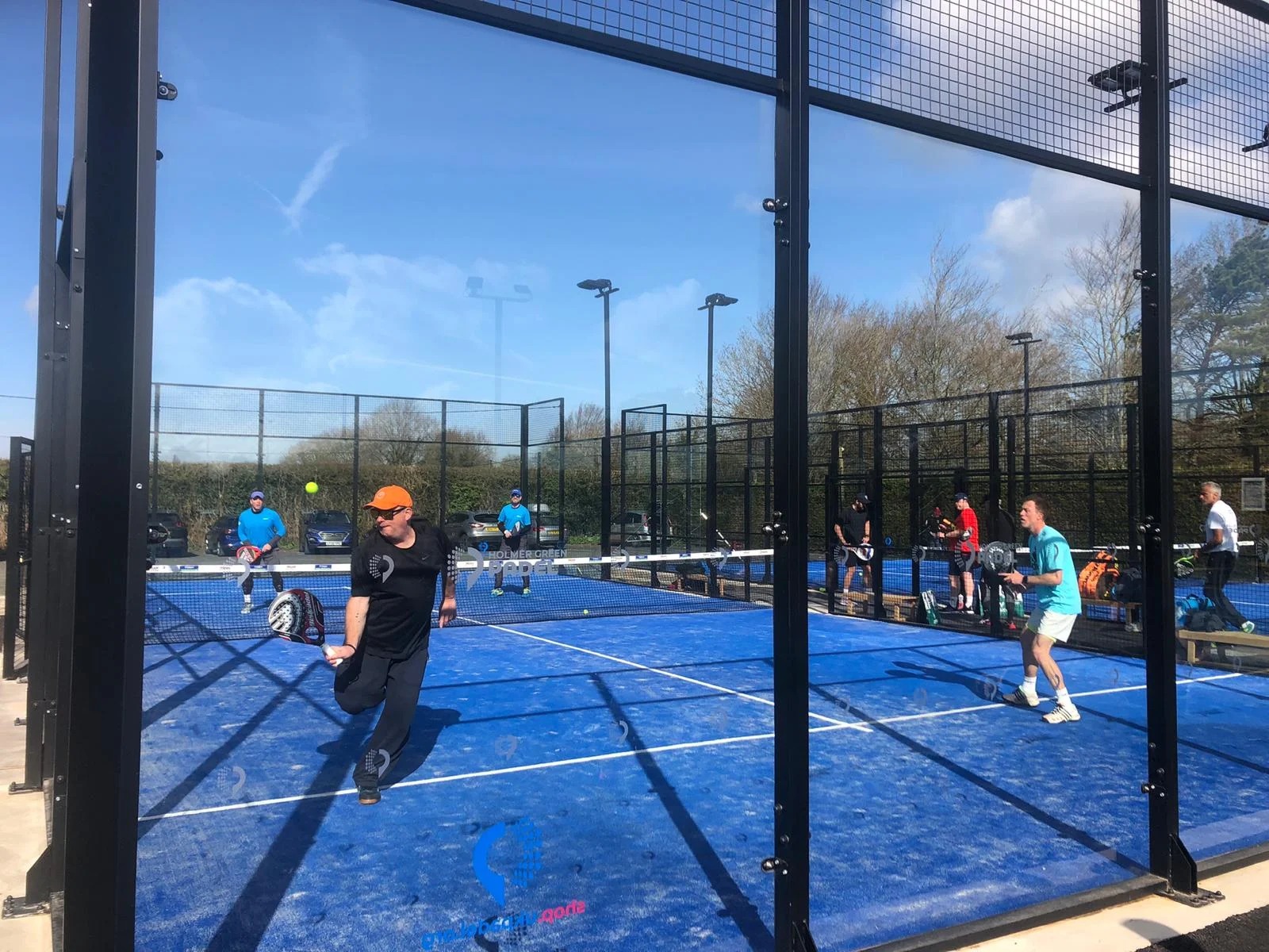 Players mid-rally at a UK padel club
